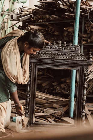 Photo of skilled workers carefully polishing wooden doors in a workshop.