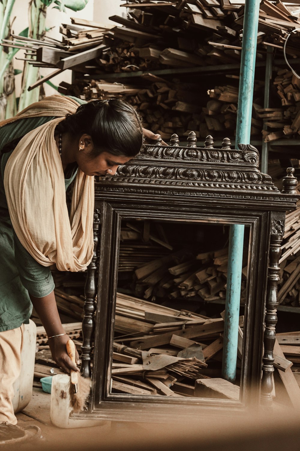 a woman is working on a table made of wood