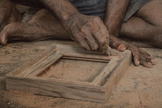 a close up of a person working on a picture frame