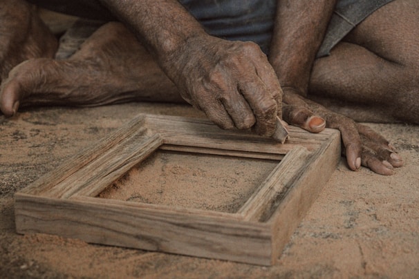 a close up of a person working on a picture frame