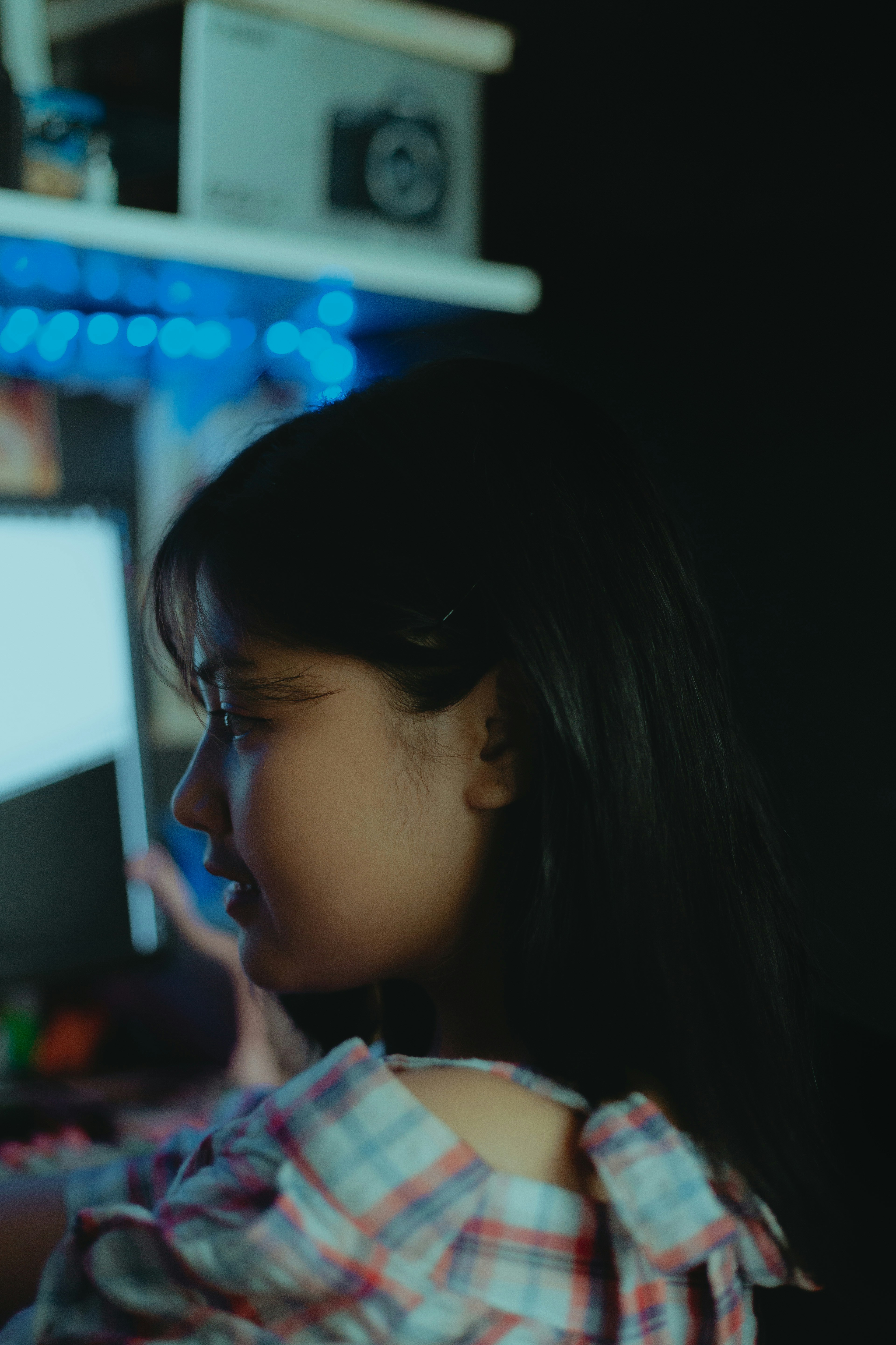 A young girl sitting in front of a computer monitor photo – Free Face ...