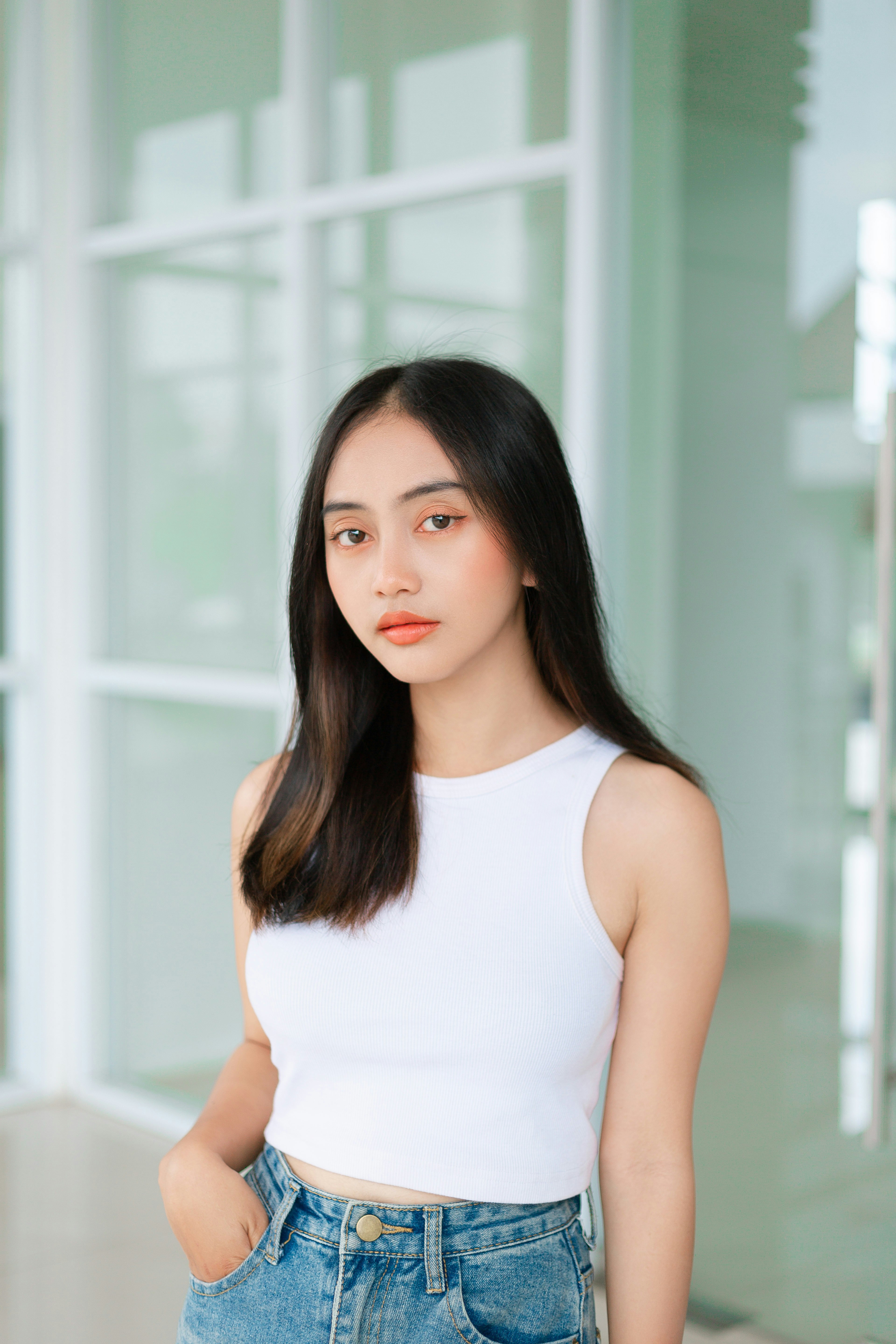 A woman with long black hair wearing a white top photo – Free Portrait ...