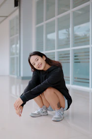 Smiling woman finishing her glute workout routine in a cozy living room