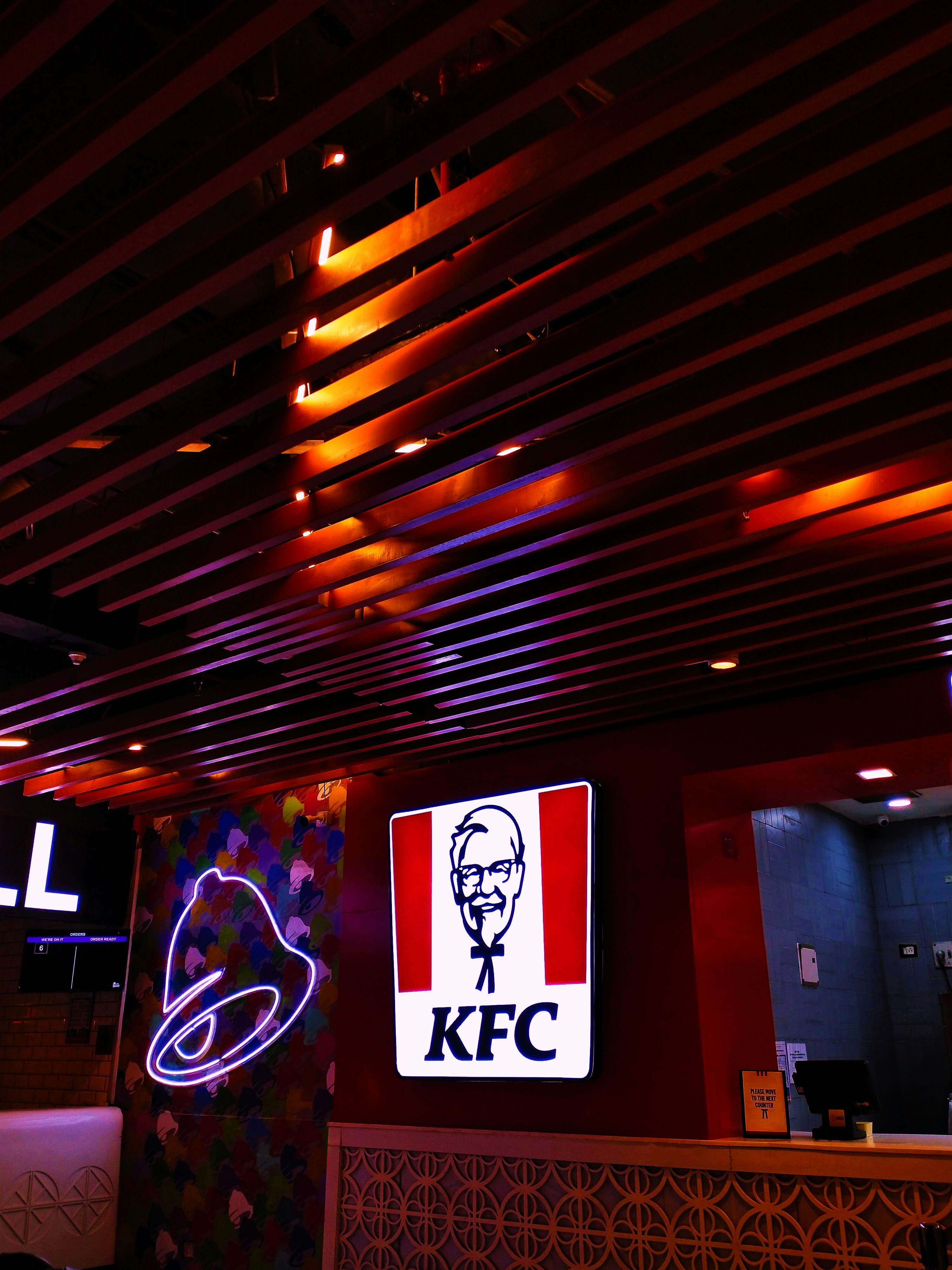 a restaurant with a neon sign and a picture of a man's face on