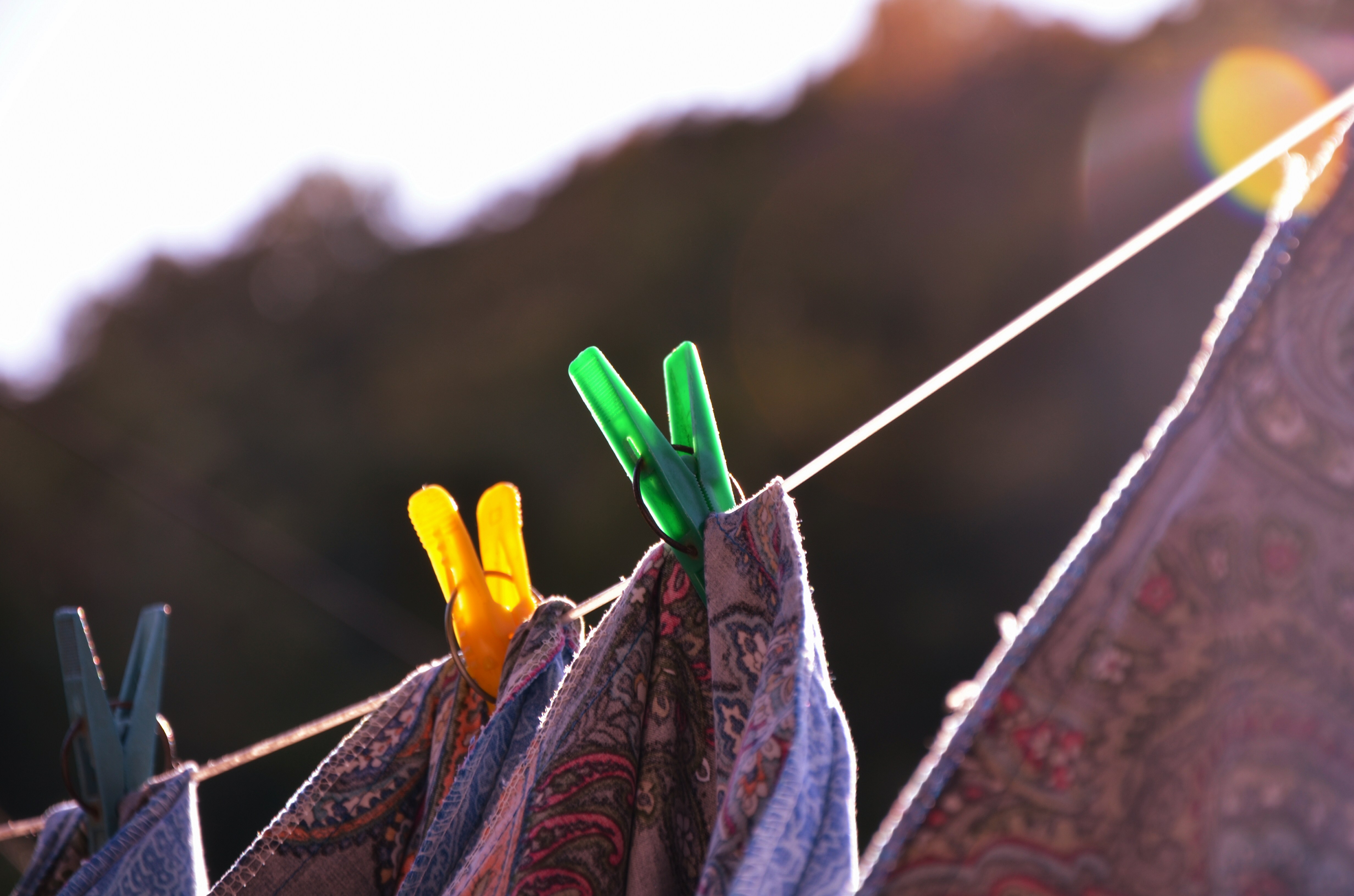 clothes hanging on a clothes line with clothes pins sticking out of them