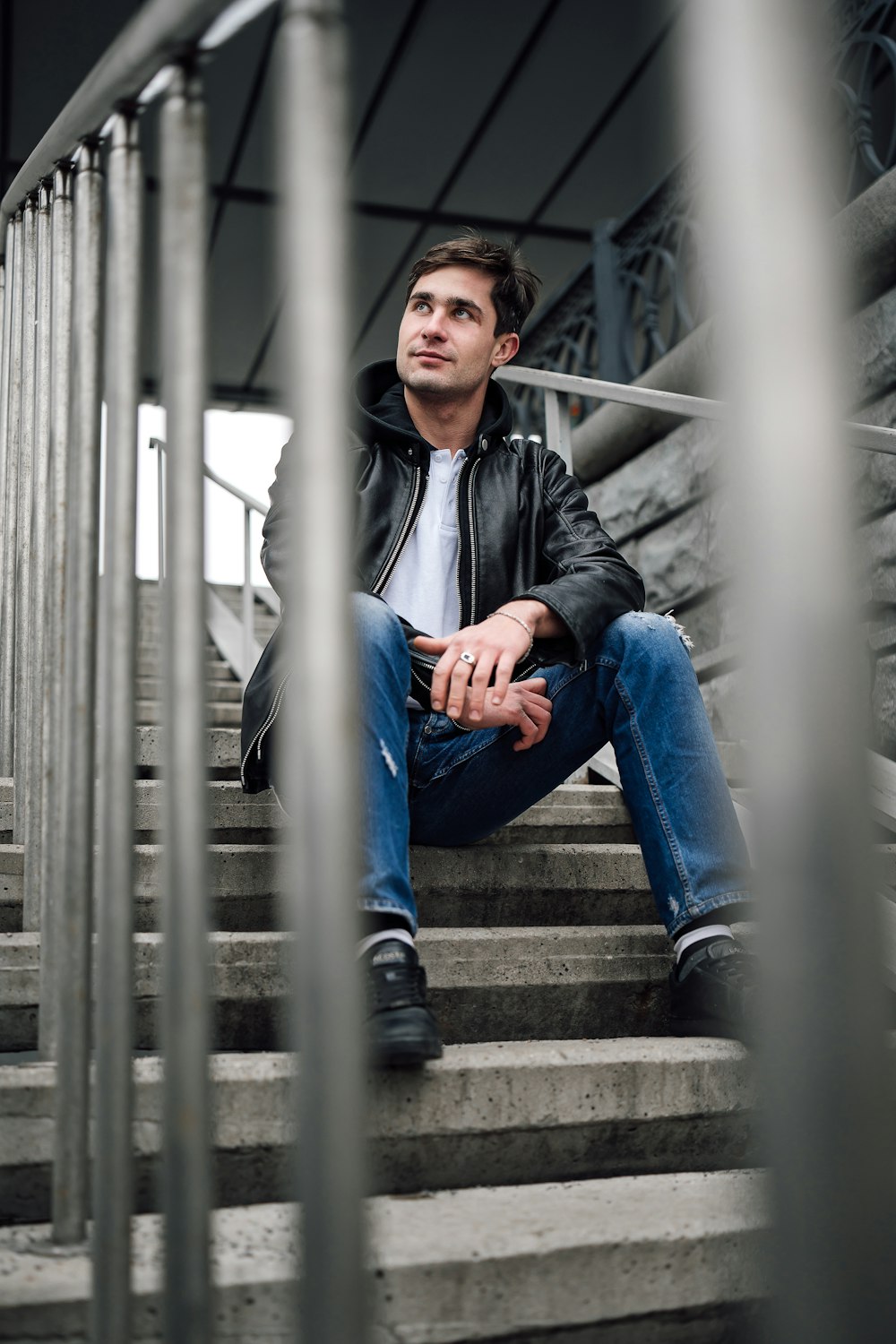 a man sitting on the steps of a building