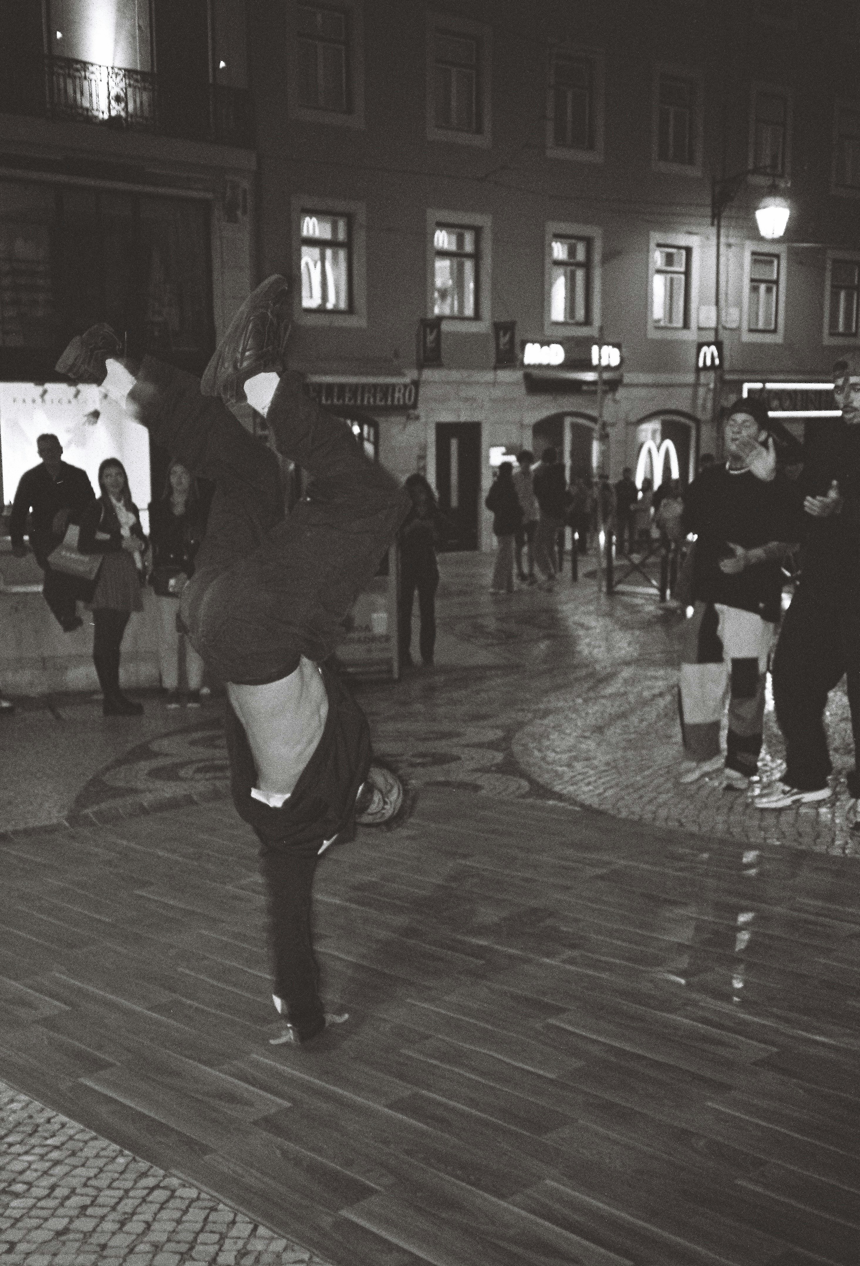 a man doing a trick on a skateboard on a city street