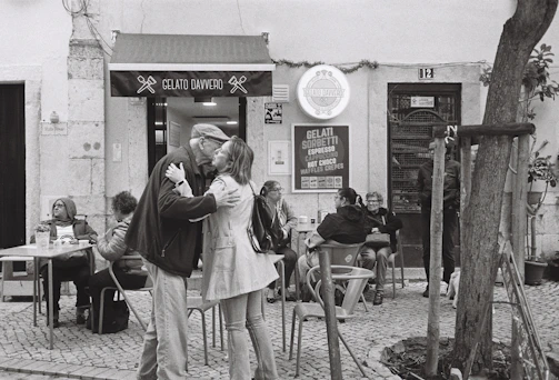 A joyful group sharing vegan treats and gelato in a warm, Mediterranean-style setting.