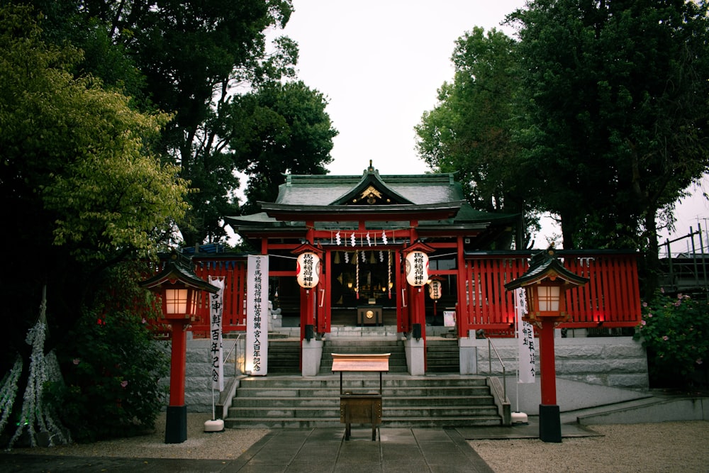 a red and white building surrounded by trees