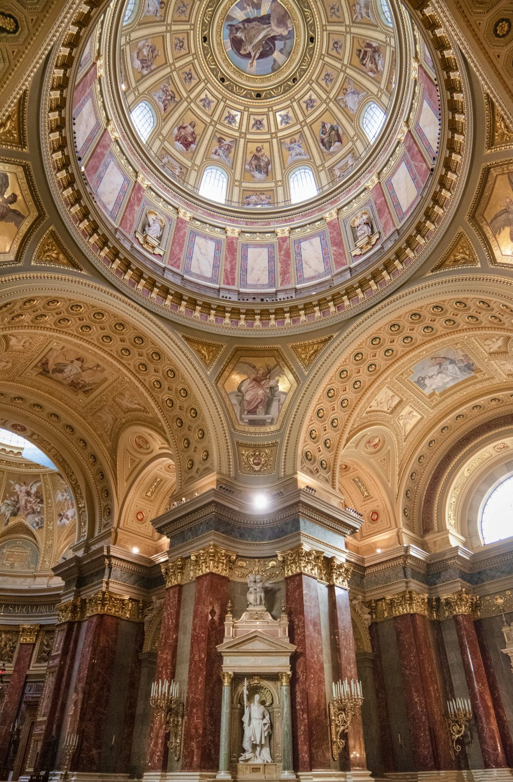 a church with a domed ceiling and a statue in the center