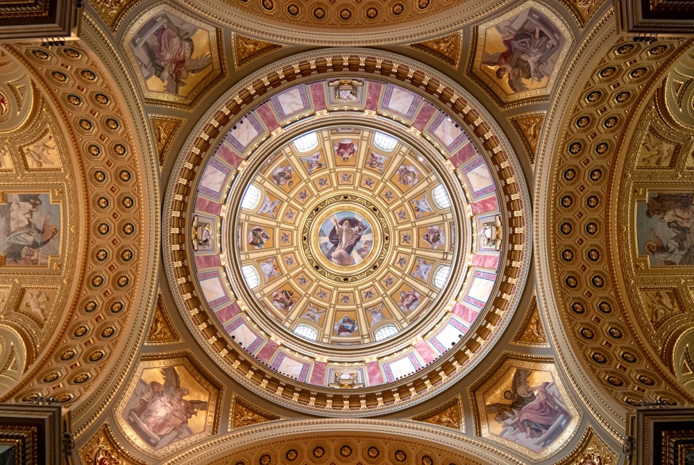 the ceiling of a building with a dome and paintings on it