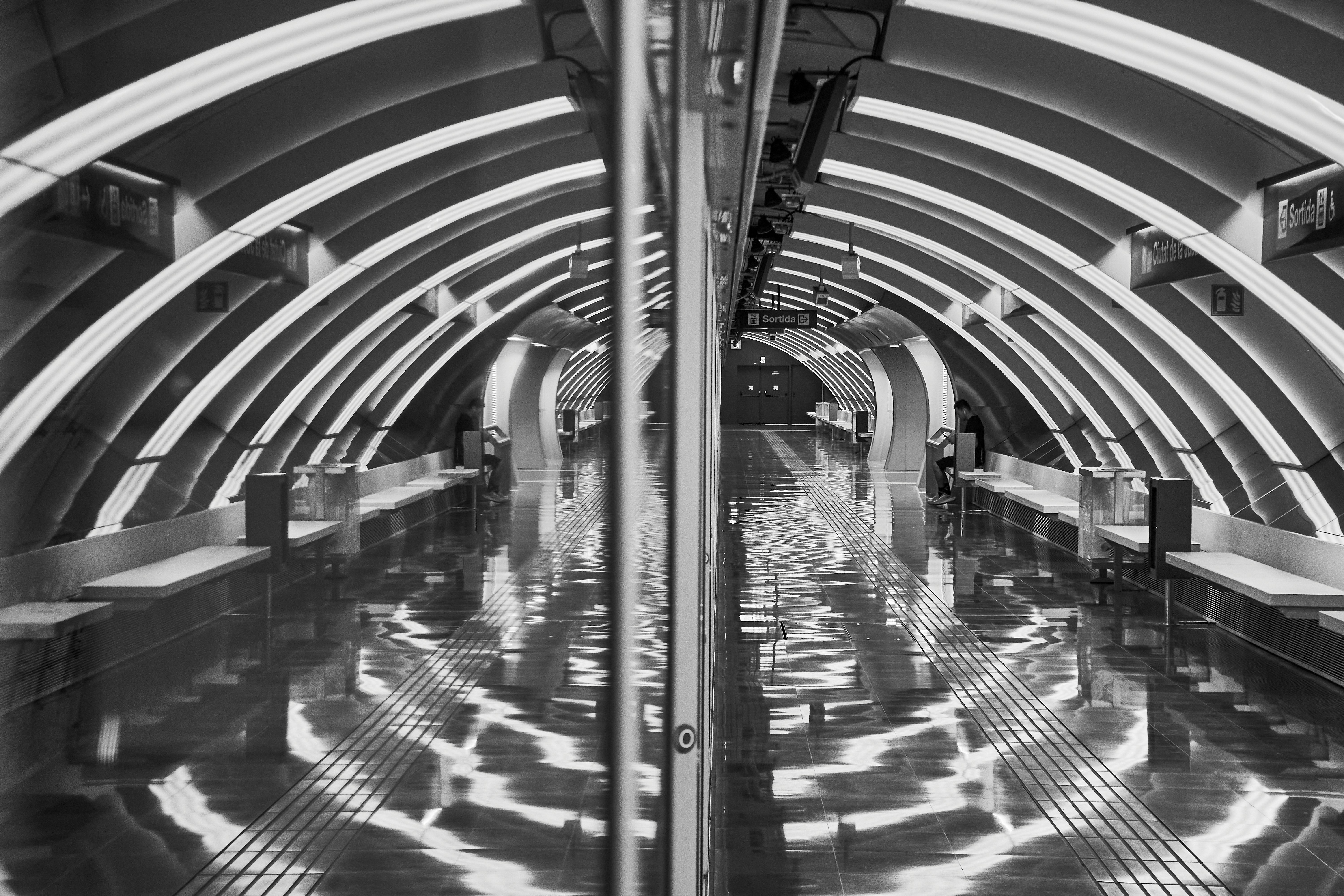 a black and white photo of a subway station