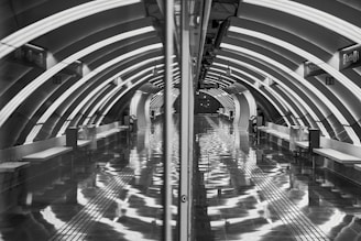 Interior view of a newly renovated underground railway station with modern lighting and signage.