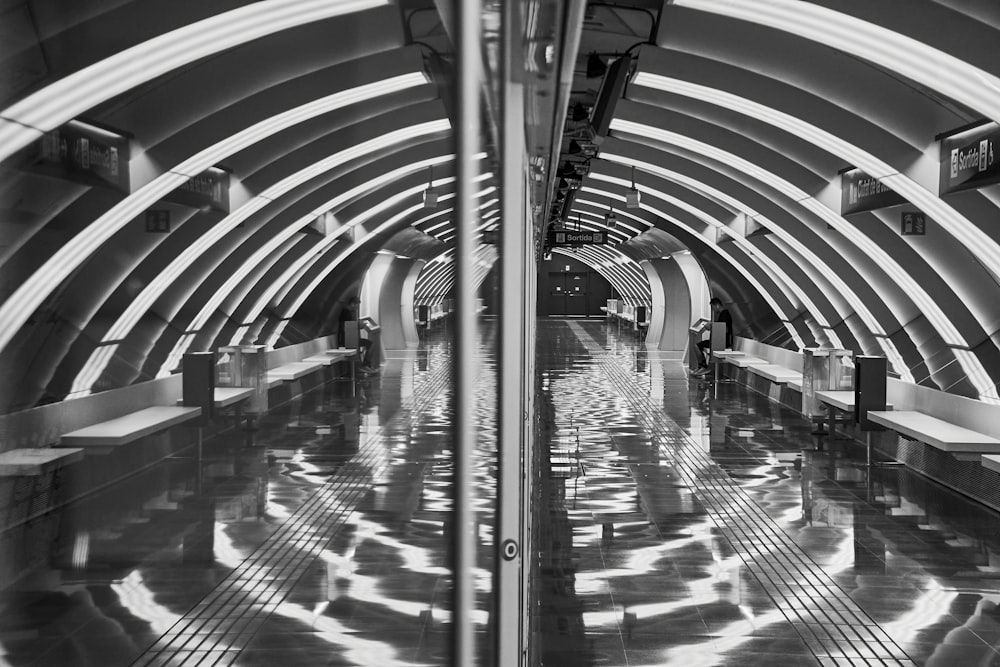 a black and white photo of a subway station