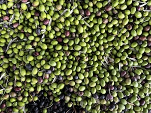 a large pile of olives and other fruits