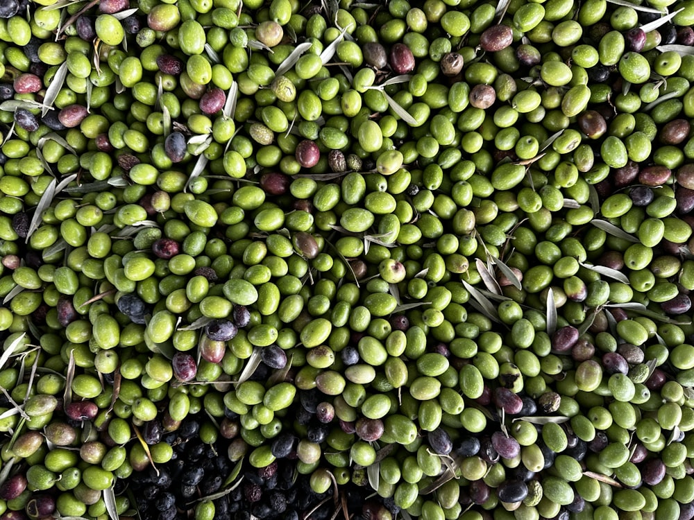 a large pile of olives and other fruits