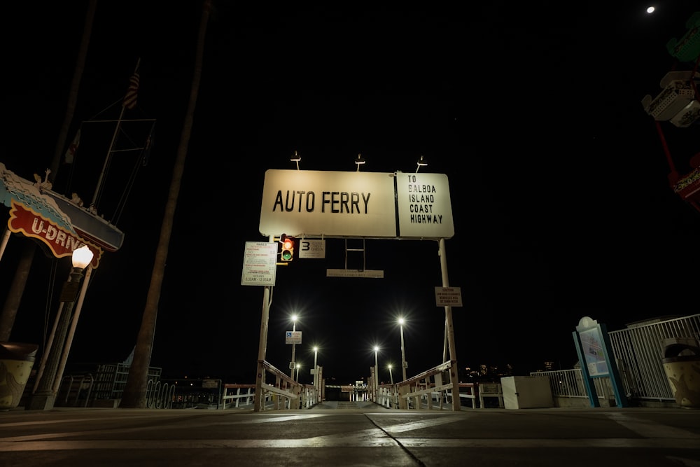 a street sign that reads auto ferry at night