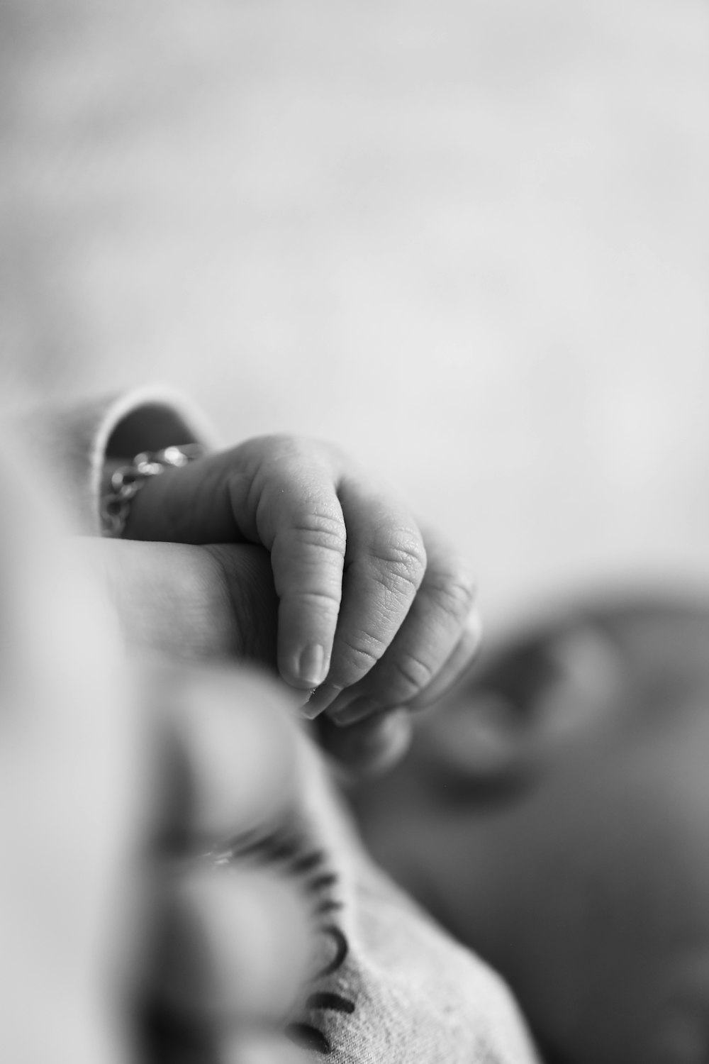 a black and white photo of a baby's hand