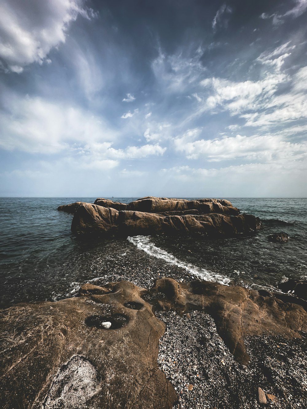 a rock outcropping in the middle of the ocean