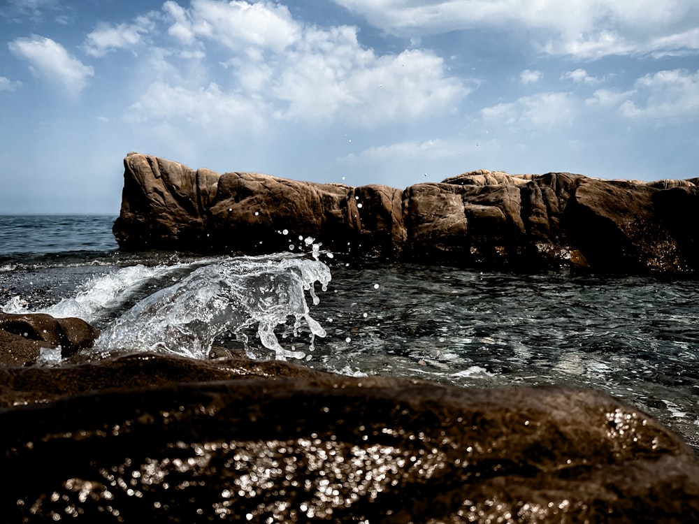 a large rock sticking out of the ocean