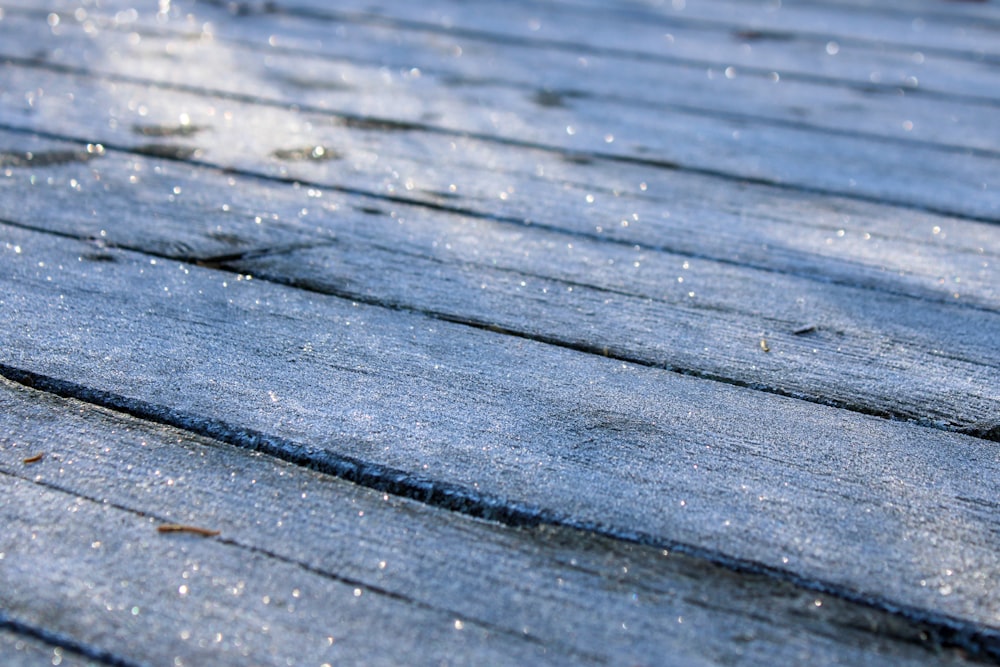 a close up of a wooden roof with snow on it