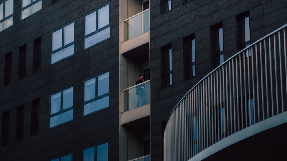 a person standing on a balcony of a building