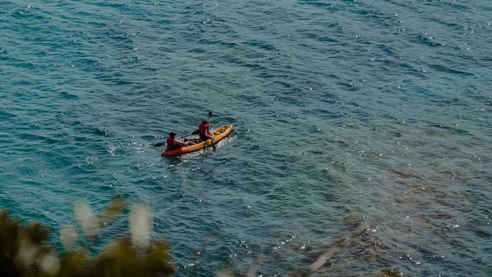 a couple of people in a kayak in the water