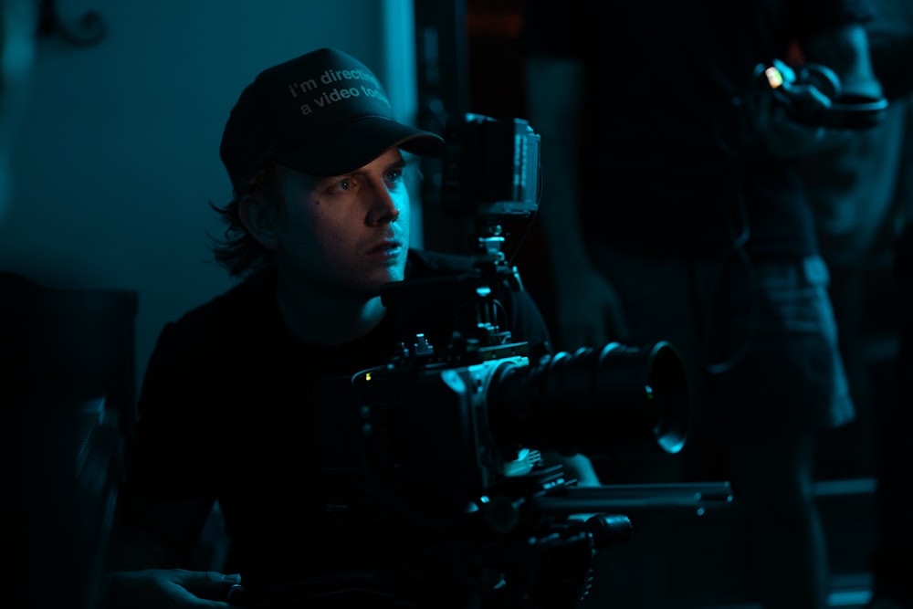 a man with a camera in a dark room