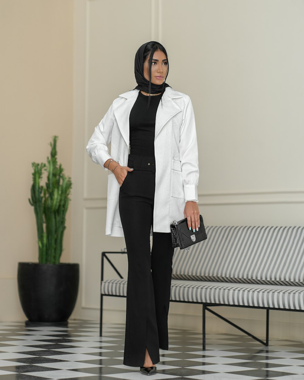 a woman in a white jacket and black pants