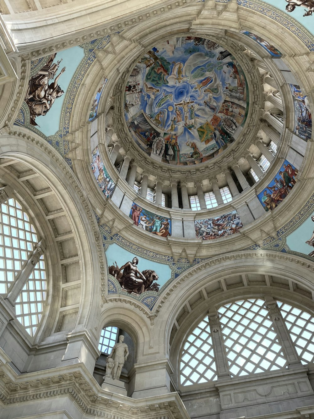 the ceiling of a large building with many windows