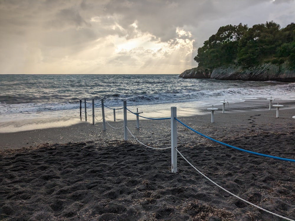 a beach with a roped off area next to the ocean