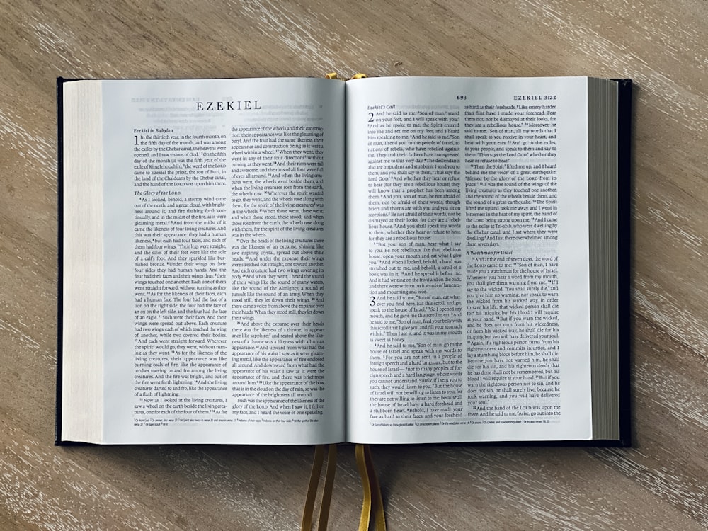 an open book sitting on top of a wooden table