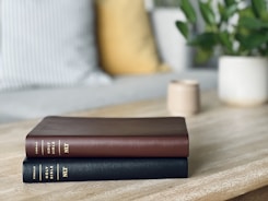 a couple of books sitting on top of a wooden table
