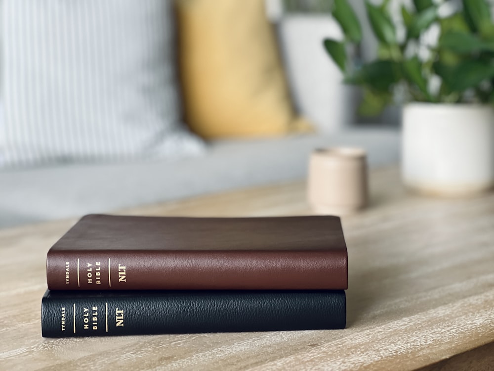 a couple of books sitting on top of a wooden table