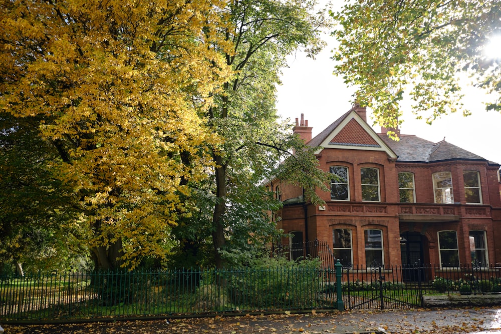 a large red brick house surrounded by trees