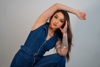 a woman with a tattoo on her arm posing for a picture