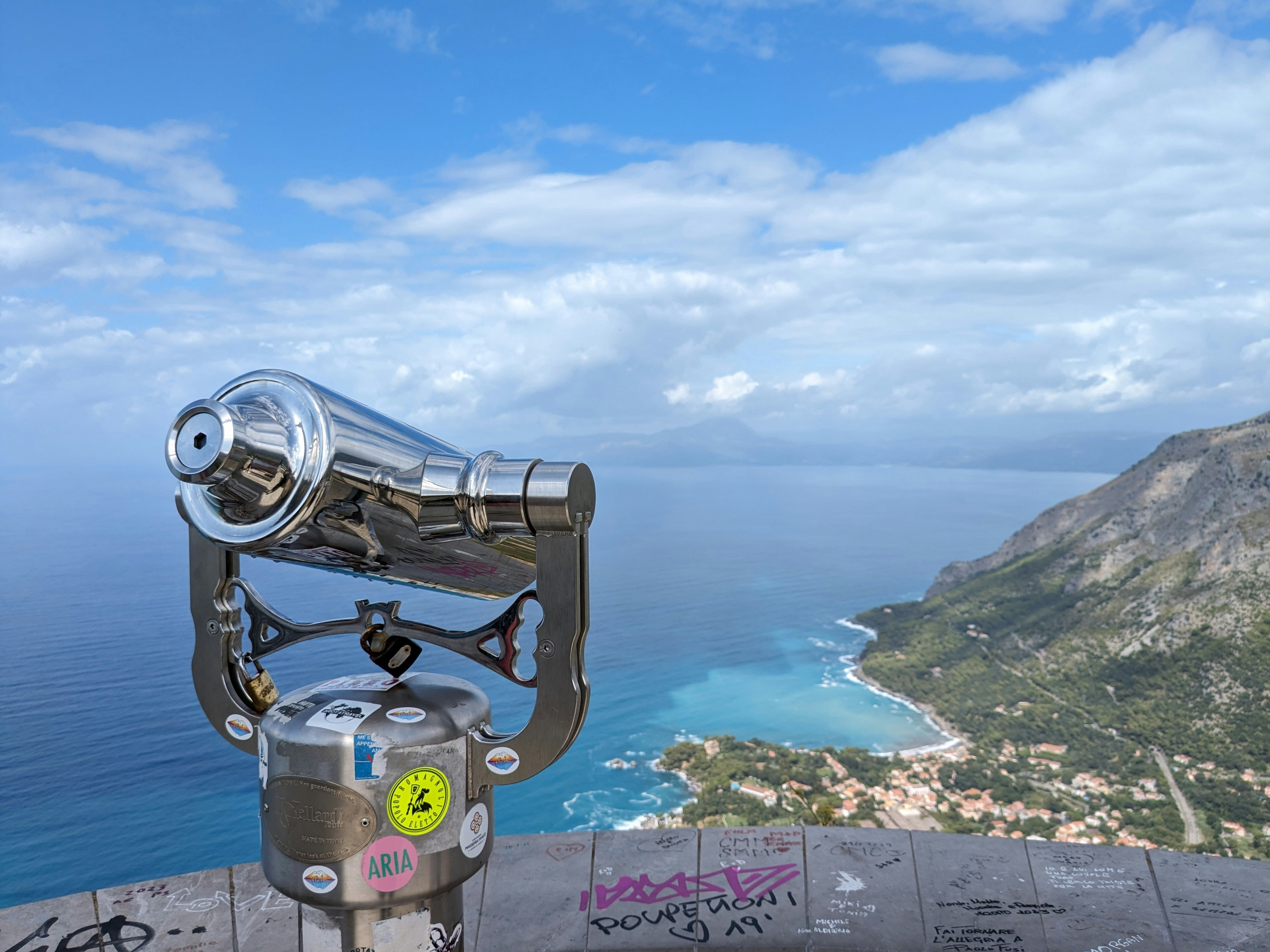 a telescope on top of a hill overlooking the ocean