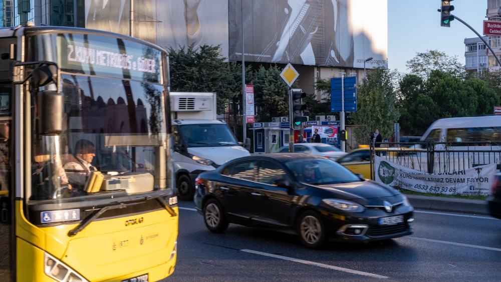 a yellow and black double decker bus driving down a street