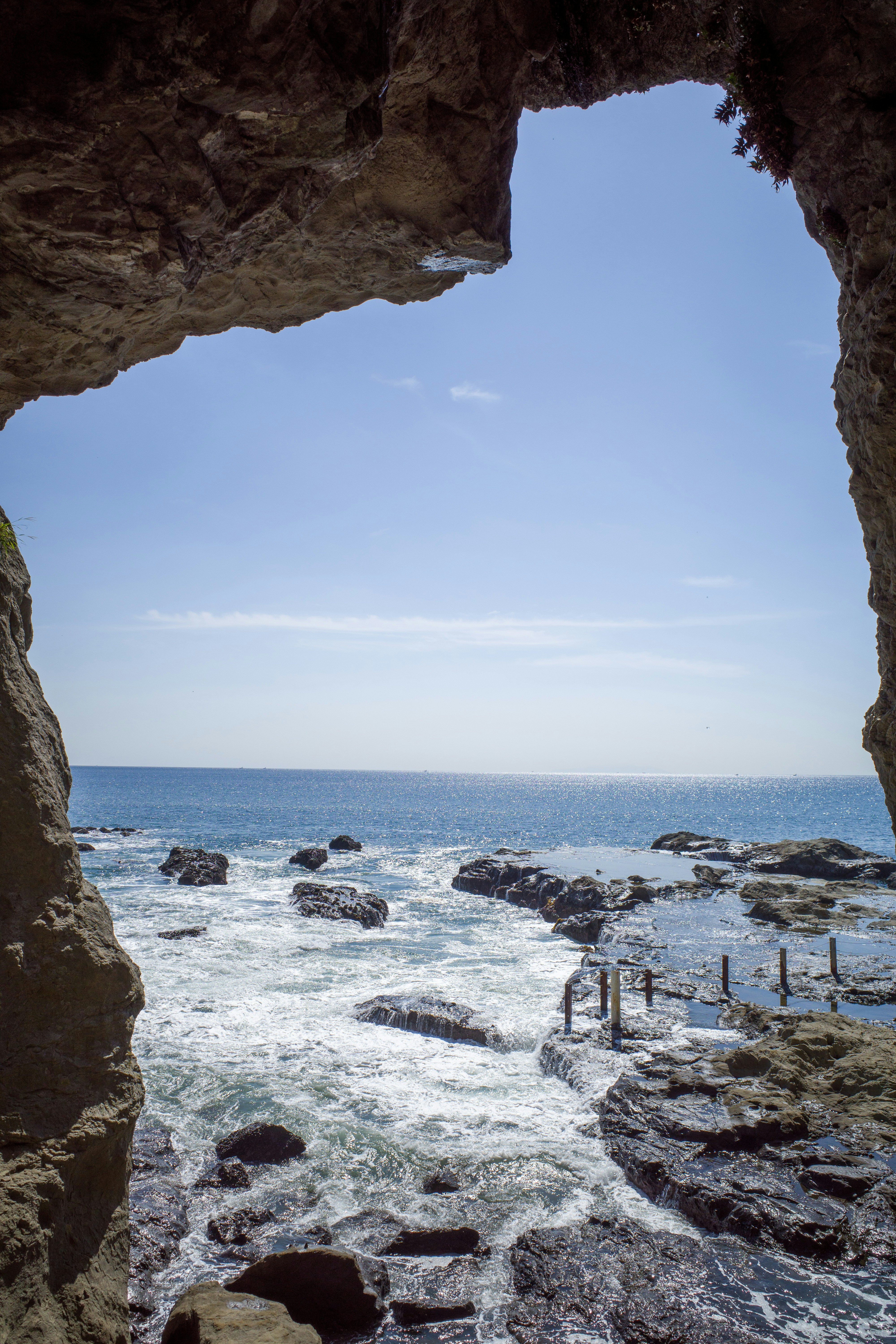 a view of the ocean from inside a cave