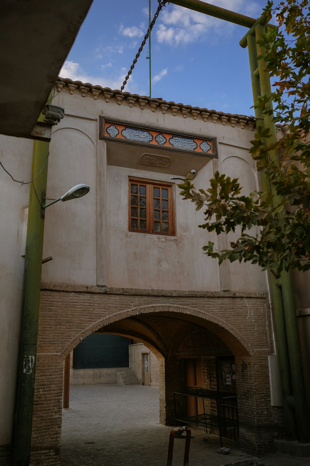 a building with an archway and a clock on the side of it