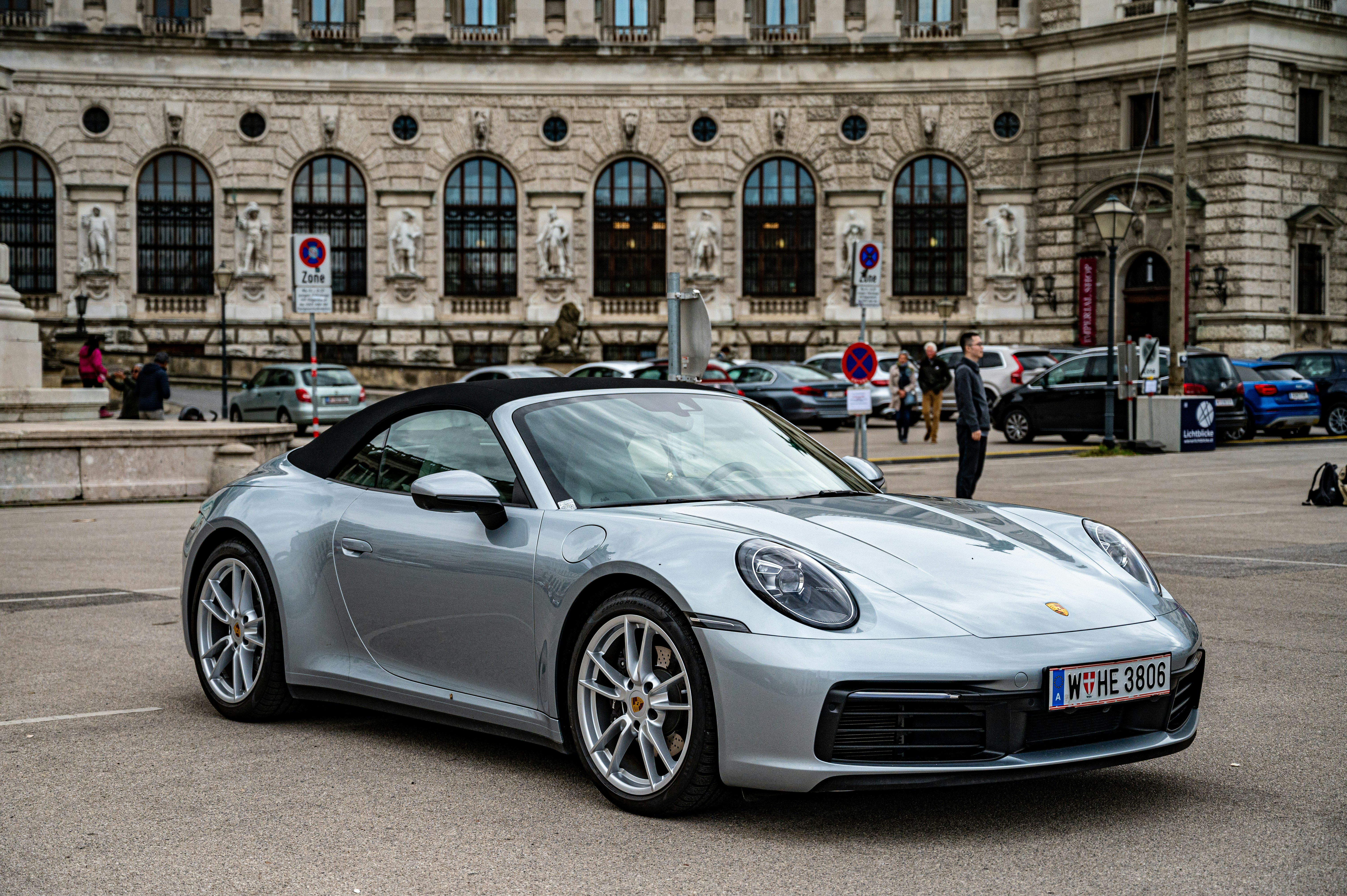a silver sports car parked in front of a building