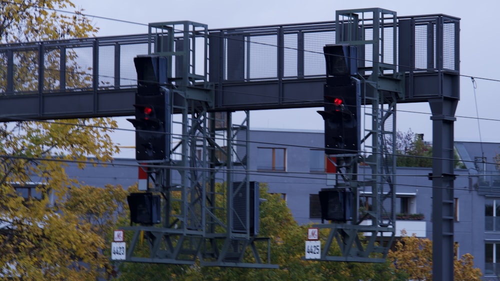 a couple of traffic lights hanging from the side of a building