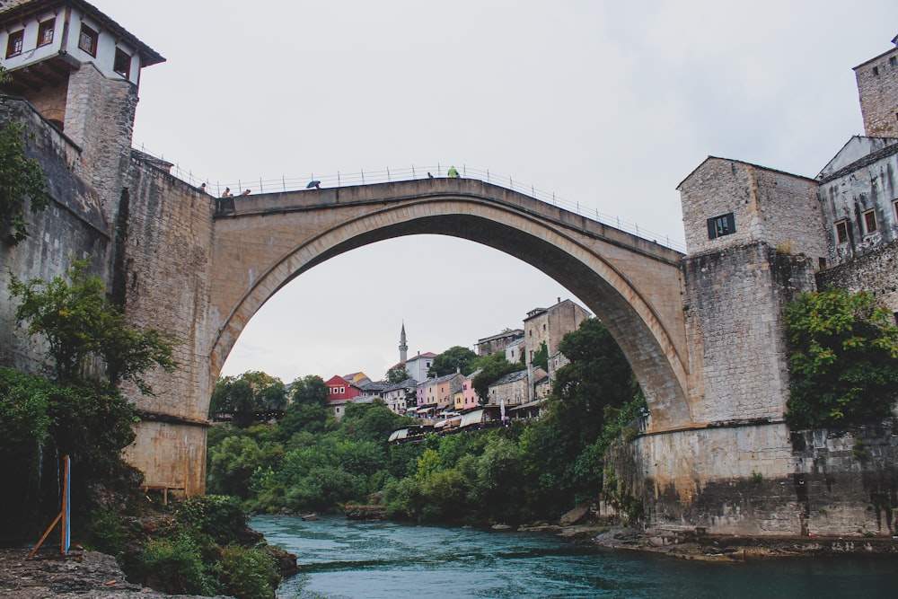 a bridge over a river with buildings on the other side