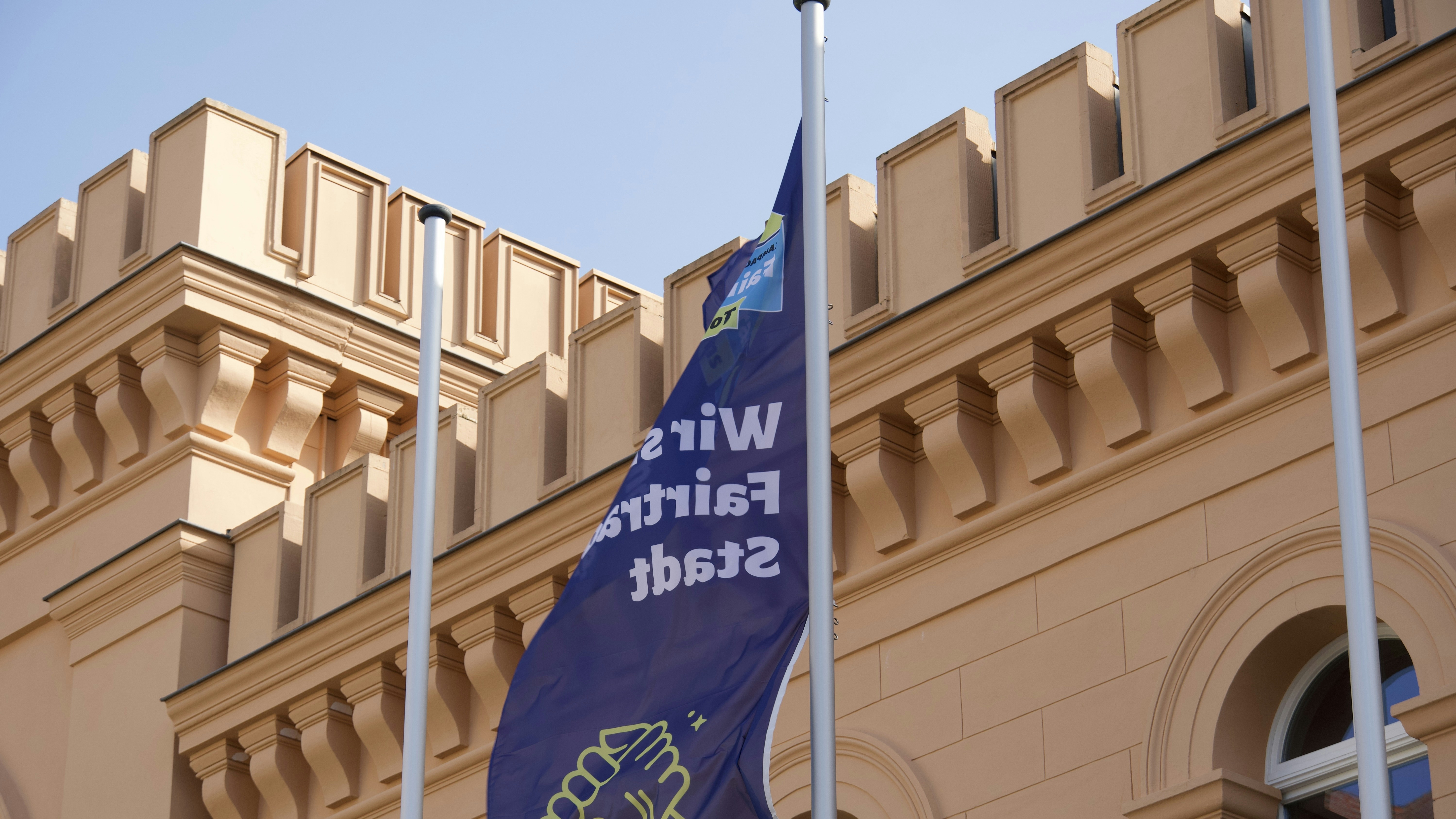 a blue and white flag on a pole in front of a building