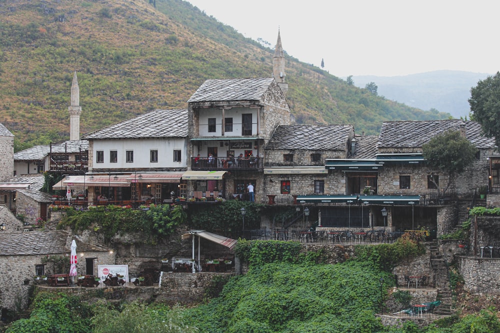 a large building with a steep hill in the background