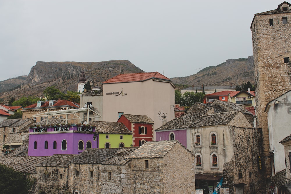 a group of buildings with a mountain in the background