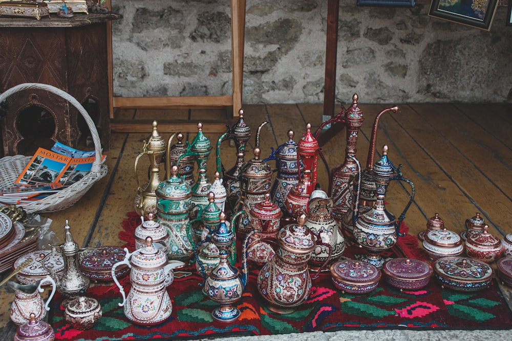 a collection of teapots on a rug in a room