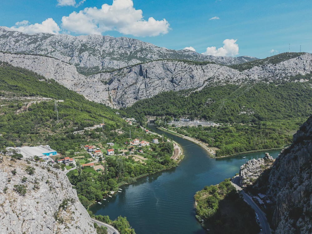 a river running through a valley surrounded by mountains