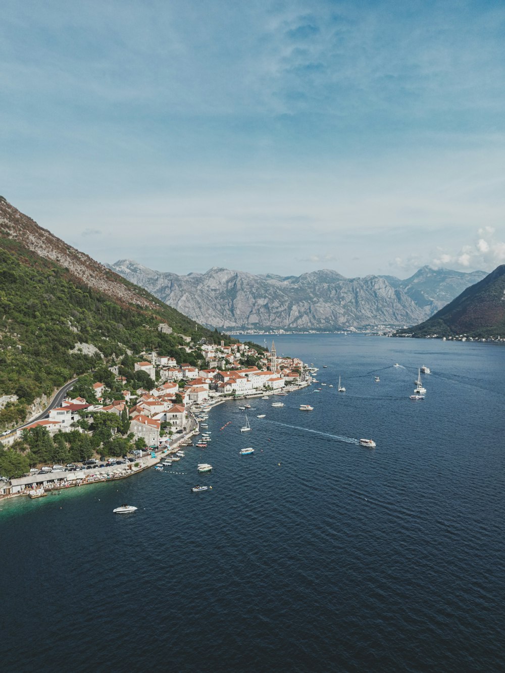 a body of water surrounded by mountains and boats