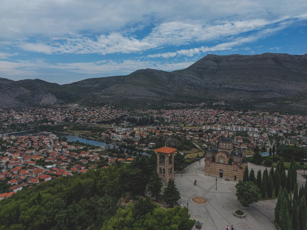 an aerial view of a city with mountains in the background